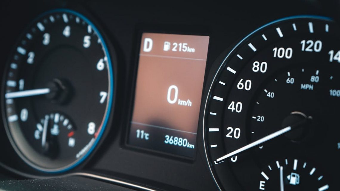 Detailed view of a car dashboard featuring speedometer and digital display showing 0 km/h.
