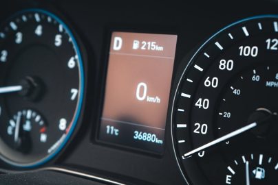 Detailed view of a car dashboard featuring speedometer and digital display showing 0 km/h.